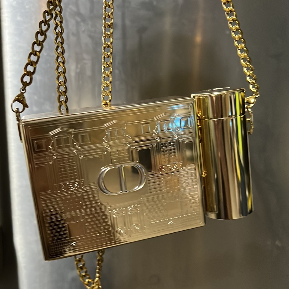 Dior lipstick holder crossbody using an included chain.
